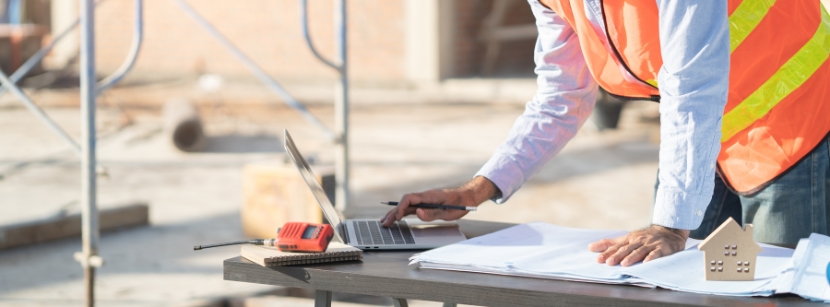 Construction worker looking at a laptop